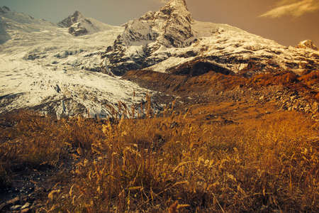 Mountain Valley, Alpine landscape areas. Panoramic view of mountains, trees, glacier.の写真素材