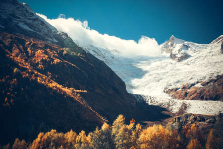Mountain Valley, Alpine landscape areas. Panoramic view of mountains, trees, glacier.の写真素材