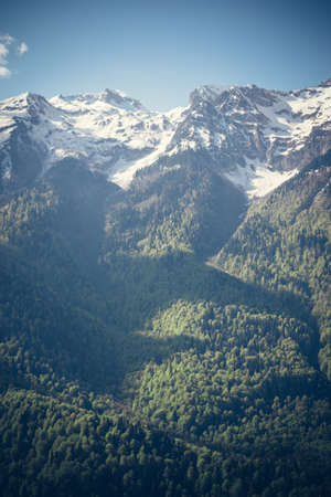 Mountains green valley and high snow-capped peaks. Landscape Summer Travel. Scenic panoramic view of...