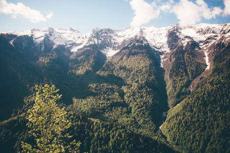 Mountains green valley and high snow-capped peaks. Landscape Summer Travel. Scenic panoramic view of...