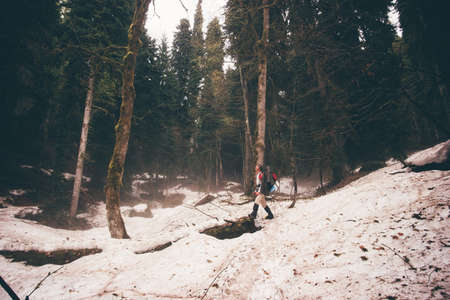 Travelers winter mountains with a backpack and sticks. Outdoor holiday lifestyle travel concept.
