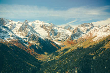 The mountain autumn landscape with colorful forest and high peaks Caucasus Mountainsの写真素材