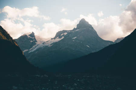 Mountain summer landscape with forest and high peaks. Caucasus. Russia. A view of the main Caucasian ridge. Biosphere Reserve resort Dombay. The concept of travel and tourism.の写真素材