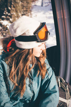 Happy girl on ski resort. Snowboarder on vacation. Lifestyle Concept Adventure winter physical activities.の写真素材