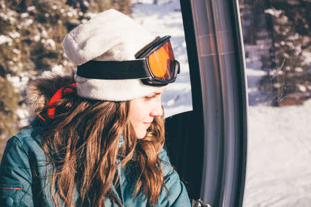 Happy girl on ski resort. Snowboarder on vacation. Lifestyle Concept Adventure winter physical activities.の写真素材