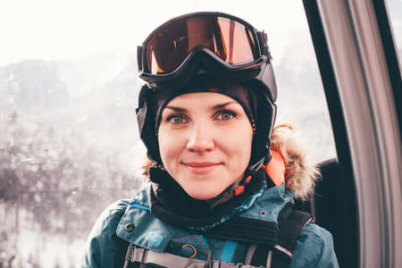 Happy girl on ski resort. Snowboarder on vacation. Lifestyle Concept Adventure winter physical activities.の写真素材