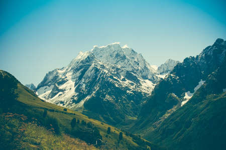 Mountain summer landscape with forest and high peaks. Caucasus. A view of the main Caucasian ridge. Biosphere Reserve resort Dombay. The concept of travel and tourism.の写真素材