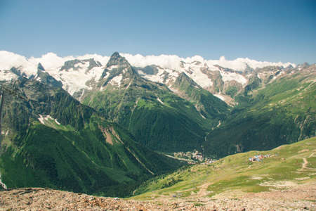 Mountain summer landscape with forest and high peaks. Caucasus. A view of the main Caucasian ridge. Biosphere Reserve resort Dombay. The concept of travel and tourism.の写真素材