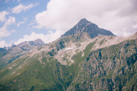 Mountain summer landscape with forest and high peaks. Caucasus. A view of the main Caucasian ridge. Biosphere Reserve resort Dombay. The concept of travel and tourism.の写真素材