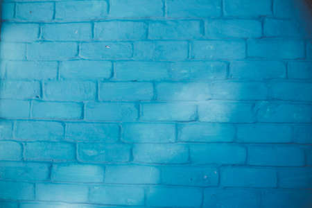 Abstract background texture of a wall. Plastered old brick wall, shabby uneven surface with whitewashing. Painted surface of the house wall.の写真素材