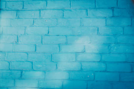 Abstract background texture of a wall. Plastered old brick wall, shabby uneven surface with whitewashing. Painted surface of the house wall.の写真素材