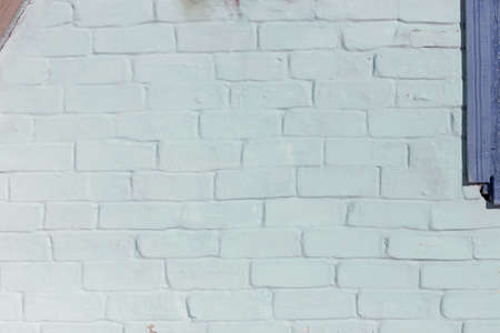 Abstract background texture of a wall. Plastered old brick wall, shabby uneven surface with whitewashing. Painted surface of the house wall.の写真素材