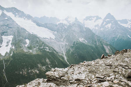 Mountains landscape high peaks scenery wild nature calm scene. Lifestyle active travel, hiking. Scenic scenery of wild snowy mountains and alpine valleys.の写真素材