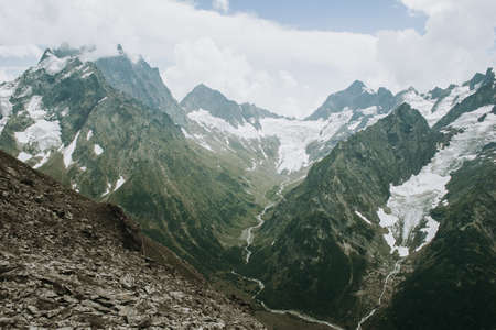 Mountains landscape high peaks scenery wild nature calm scene. Lifestyle active travel, hiking. Scenic scenery of wild snowy mountains and alpine valleys.の写真素材