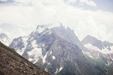 Mountains landscape high peaks scenery wild nature calm scene. Lifestyle active travel, hiking. Scenic scenery of wild snowy mountains and alpine valleys.の写真素材