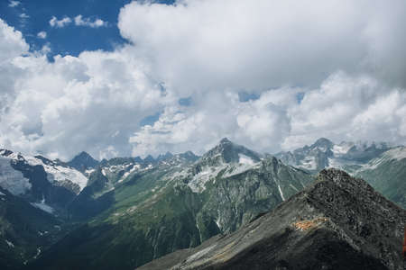 Mountains landscape high peaks scenery wild nature calm scene. Lifestyle active travel, hiking. Scenic scenery of wild snowy mountains and alpine valleys.の写真素材