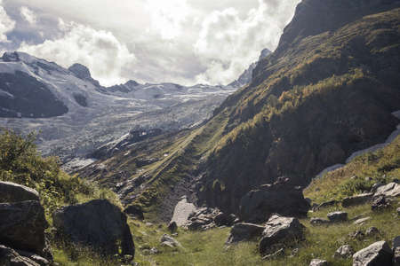 Mountains green landscape with blue sky and white clouds. Lifestyle is active, hiking, tourism. Picturesque landscapes of the Alpine mountains in the summer season.の写真素材