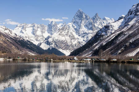 Lake and high mountains in clear weather. Summer landscape. Camping is outdoor recreation, traveling and hiking. A serene scenic epic landscape.のeditorial素材
