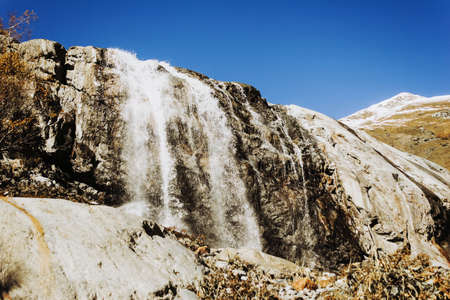 Mountains autumn landscape high peaks scenery wild nature calm scene. Lifestyle active travel, hiking. Scenic scenery of wild snowy mountains and alpine valleys.の写真素材