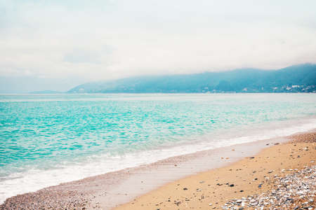 Panorama of the turquoise sea from the coastline. View of a tropical paradise of places, blue waves and shore against a sky background on a clear day. Concept travel, leisure, lifestyle.の写真素材