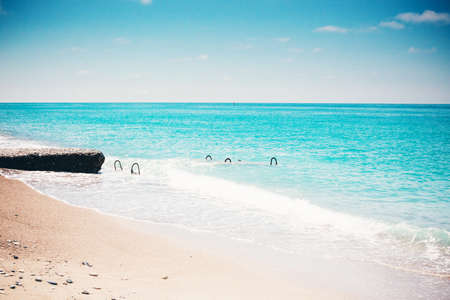 Panorama of the turquoise sea from the coastline. View of a tropical paradise of places, blue waves and shore against a sky background on a clear day. Concept travel, leisure, lifestyle.の写真素材