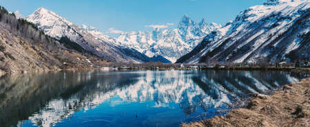 Lake and high mountains in clear weather. Summer landscape. Camping is outdoor recreation, traveling and hiking. A serene scenic epic landscape.の写真素材