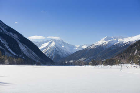 Winter panorama of the mountain with valleys and forest. Caucasus. Landscape of high peaks in clear weather. The concept of travel and leisure, winter sports, lifestyle, adventure.の写真素材