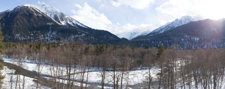 Winter panorama of the mountain with valleys and forest. Caucasus. Landscape of high peaks in clear weather. The concept of travel and leisure, winter sports, lifestyle, adventure.の写真素材