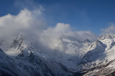 Winter mountains and peaks on a clear day. Caucasus. Landscape winter views in the highlands. The concept of travel and leisure, winter sports, lifestyle, adventure.の写真素材