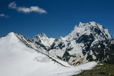 Mountain landscapes and summits on a sunny day. Caucasus. Landscape alpine species in the summer season. The concept of travel and recreation, winter sports, lifestyle, adventure.の写真素材