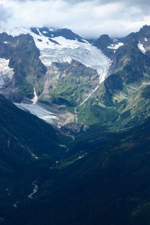 Mountain landscapes and summits on a sunny day. Caucasus. Landscape alpine species in the summer season. The concept of travel and recreation, winter sports, lifestyle, adventure.の写真素材