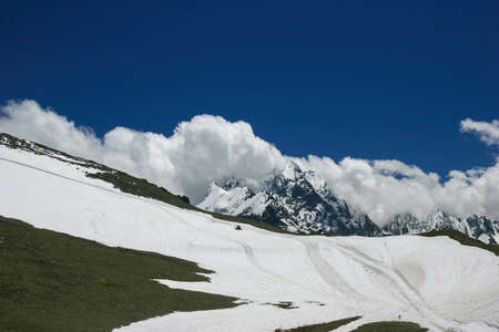 Mountain landscapes and summits on a sunny day. Caucasus. Landscape alpine species in the summer season. The concept of travel and recreation, winter sports, lifestyle, adventure.の写真素材