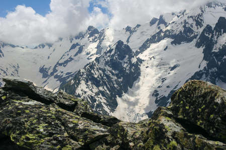 Mountain landscapes and summits on a sunny day. Caucasus. Landscape alpine species in the summer season. The concept of travel and recreation, winter sports, lifestyle, adventure.の写真素材