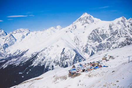 Landscape winter panorama of the mountain with ski slopes. The concept of a vacation is snowboarding and skiing, enjoying the alpine mountain scenery. The purpose of using mountains, lifestyle, snowboarding, adventure, sports and travel.の写真素材