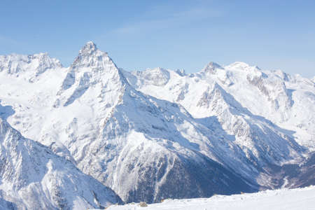 Winter mountains with high peaks. Snowboarding and skiing, enjoying the snowy landscapes. Lifestyle snowboarding, adventure, sports and travel.の写真素材