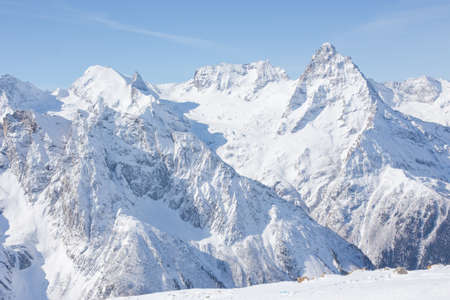 Winter mountains with high peaks. Snowboarding and skiing, enjoying the snowy landscapes. Lifestyle snowboarding, adventure, sports and travel.の写真素材