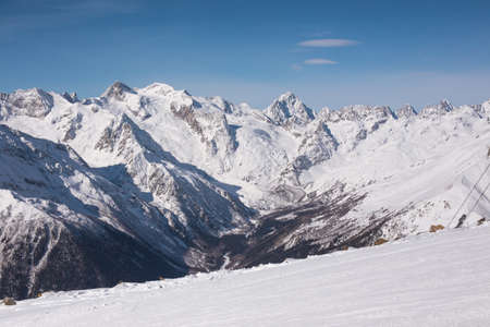 Winter mountains with high peaks. Snowboarding and skiing, enjoying the snowy landscapes. Lifestyle snowboarding, adventure, sports and travel.の写真素材