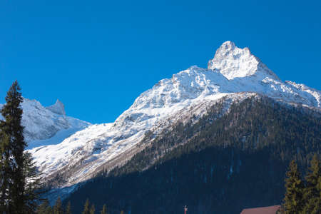 Winter mountains with high peaks. Snowboarding and skiing, enjoying the snowy landscapes. Lifestyle snowboarding, adventure, sports and travel.の写真素材