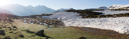 Mountains green landscape with blue sky and white clouds. Lifestyle is active, hiking, tourism. Picturesque landscapes of the Alpine mountains in the summer season.の写真素材