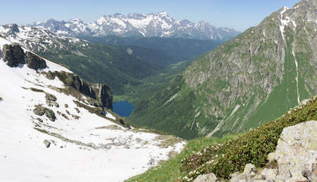 Mountains green landscape with blue sky and white clouds. Lifestyle is active, hiking, tourism. Picturesque landscapes of the Alpine mountains in the summer season.の写真素材