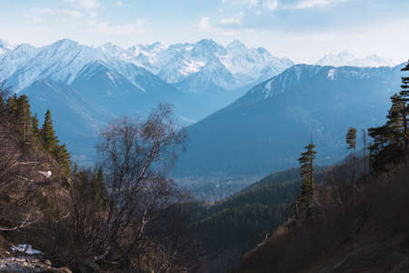 Mountains green landscape with blue sky and white clouds. Lifestyle is active, hiking, tourism. Picturesque landscapes of the Alpine mountains in the summer season.の写真素材