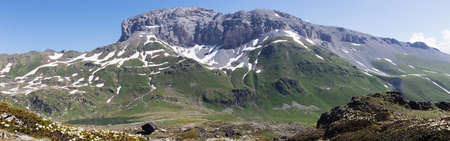 Mountain landscape in summer with high peaks, idyllic scene of alpine meadows. Lifestyle tourism and travel, adventure.の写真素材