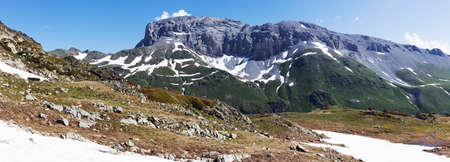 Mountain landscape in summer with high peaks, idyllic scene of alpine meadows. Lifestyle tourism and travel, adventure.の写真素材