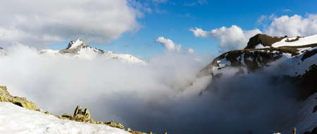 Landscape high mountains with clouds aerial view, nature travels and hikes on a sunny day.
