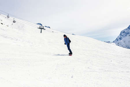 Young woman snowboarder on a slope winter. Sports background  Travel Lifestyle recreation and...