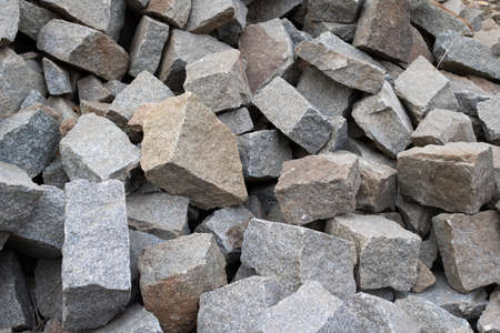 A large pile of boulder rocks. Stones for the construction industry. Stone background, gravel stone...
