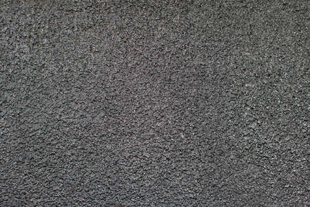Abstract black background texture from cement or bituminous resin for designs and projects. Coal cement or bitumen on a concrete surface.の写真素材