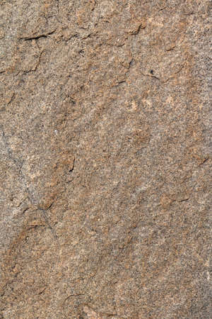 Stone background, rock wall backdrop texture. Abstract, grungy textured surface of stone material. Nature detail of rocks.の写真素材