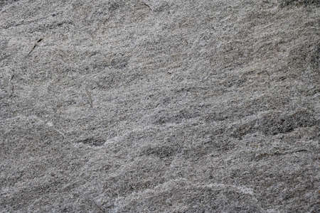 Granite stone wall texture. Background basalt rock backdrop with rough abstract. Grunge textured surface of stony material nature detail of rocks.の写真素材