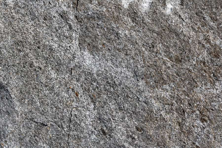 Granite stone wall texture background, rock backdrop with rough abstract, grunge textured surface of stony material. Nature detail of rocks.の写真素材